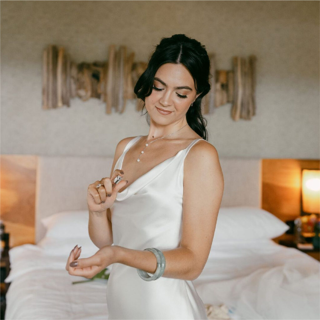 Bride smiling softly and looking down with elegant makeup